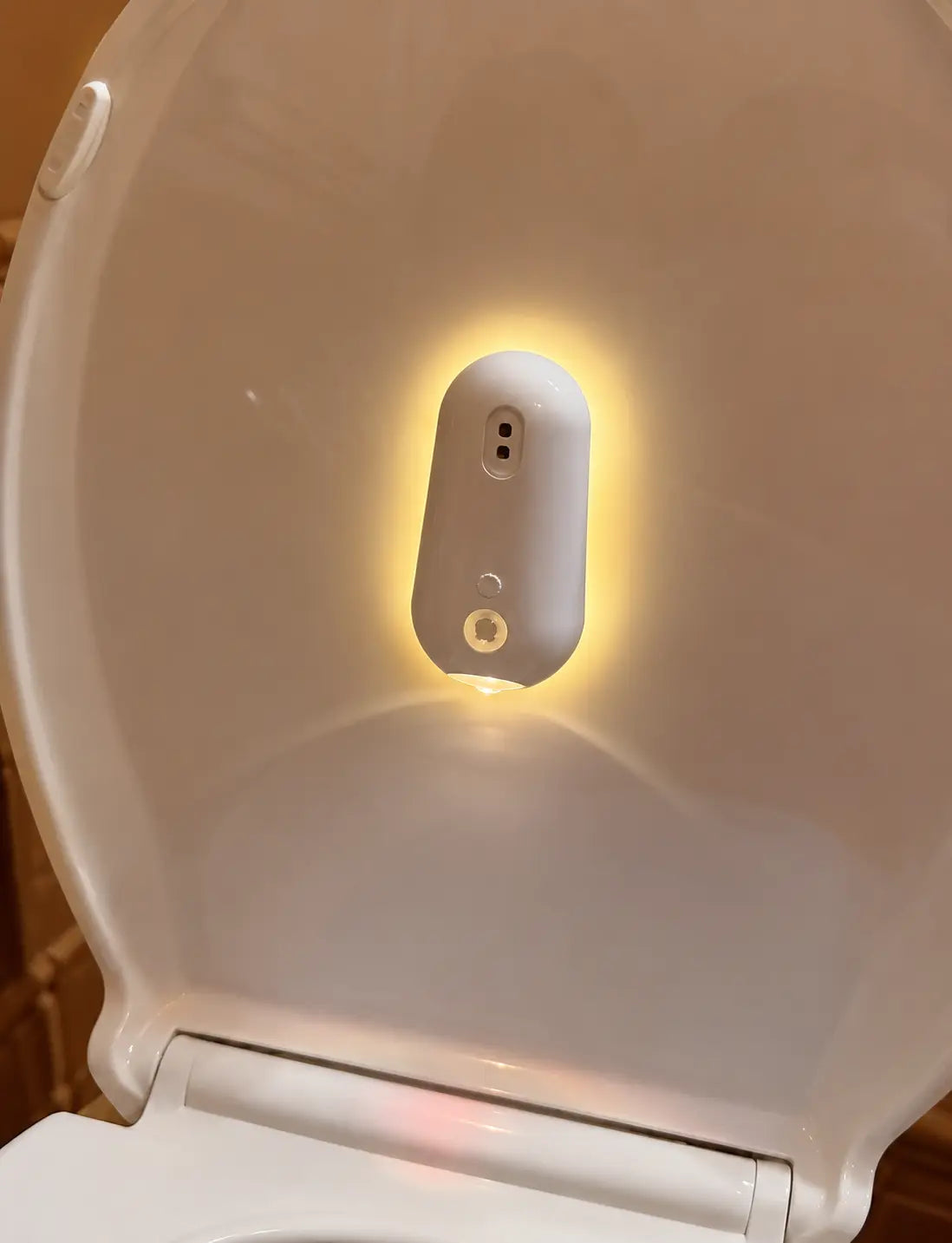 Smart toilet night light with motion sensor, warm glow illumination for bathroom safety and convenience